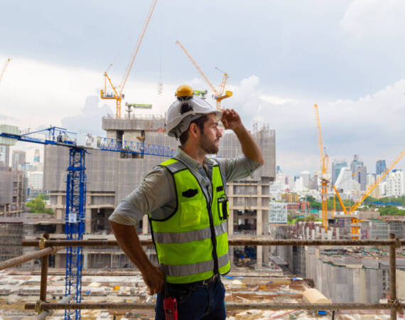 Portrait of an engineer designing a large project inspecting the job site to meet specifications.